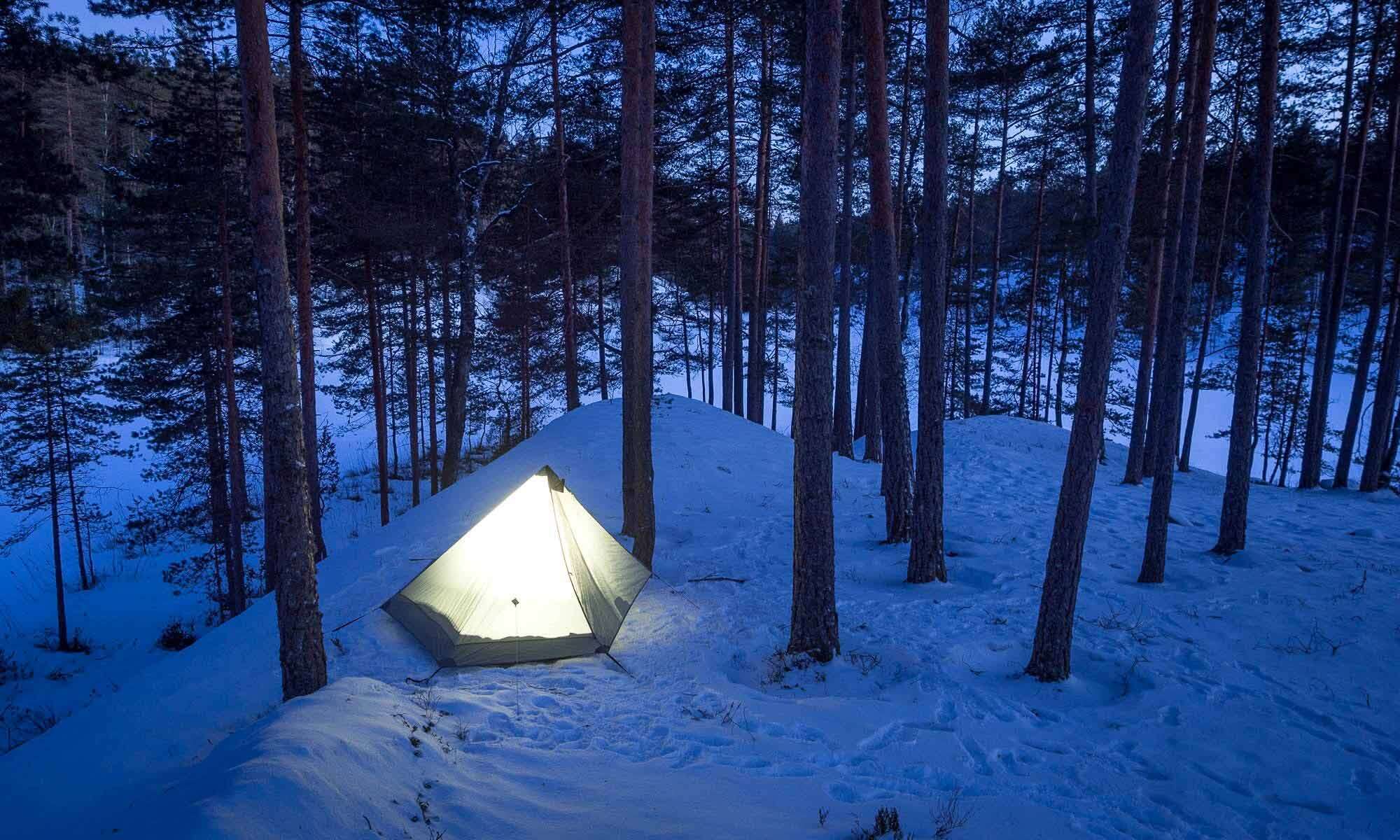 Nuuksio National Park in winter. Hiking and camping with a tent in March. Finnish nature near Helsinki, Finland.