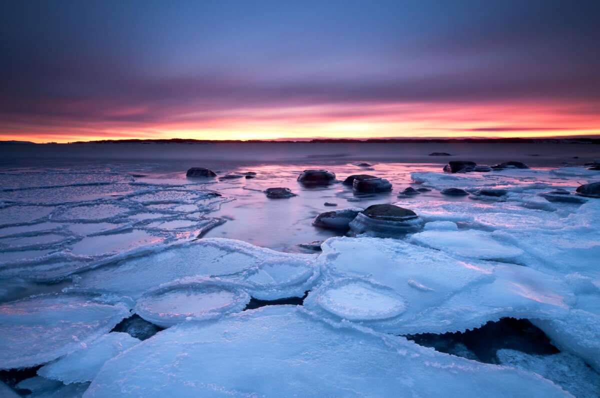 Coast of Baltic Sea around Helsinki in winter, in January. Freezing sea at sunset. Finnish nature near Helsinki, Finland.