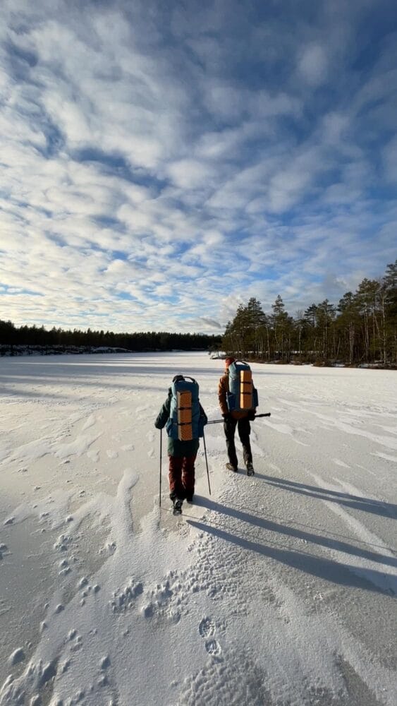 Hikers walking on a frozen lake in Nuuksio National Park, Helsinki
