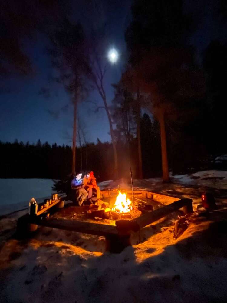 Campfire dinner on winter camping tour of Nuuksio National Park.