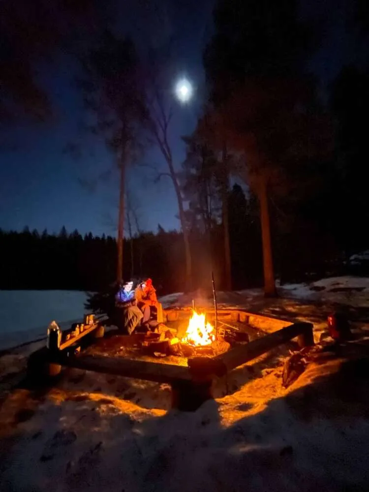 Campfire dinner on winter camping tour of Nuuksio National Park.