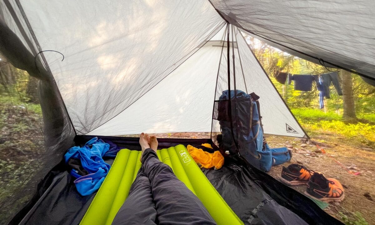 Hiker resting in a tent at Repovesi National Park
